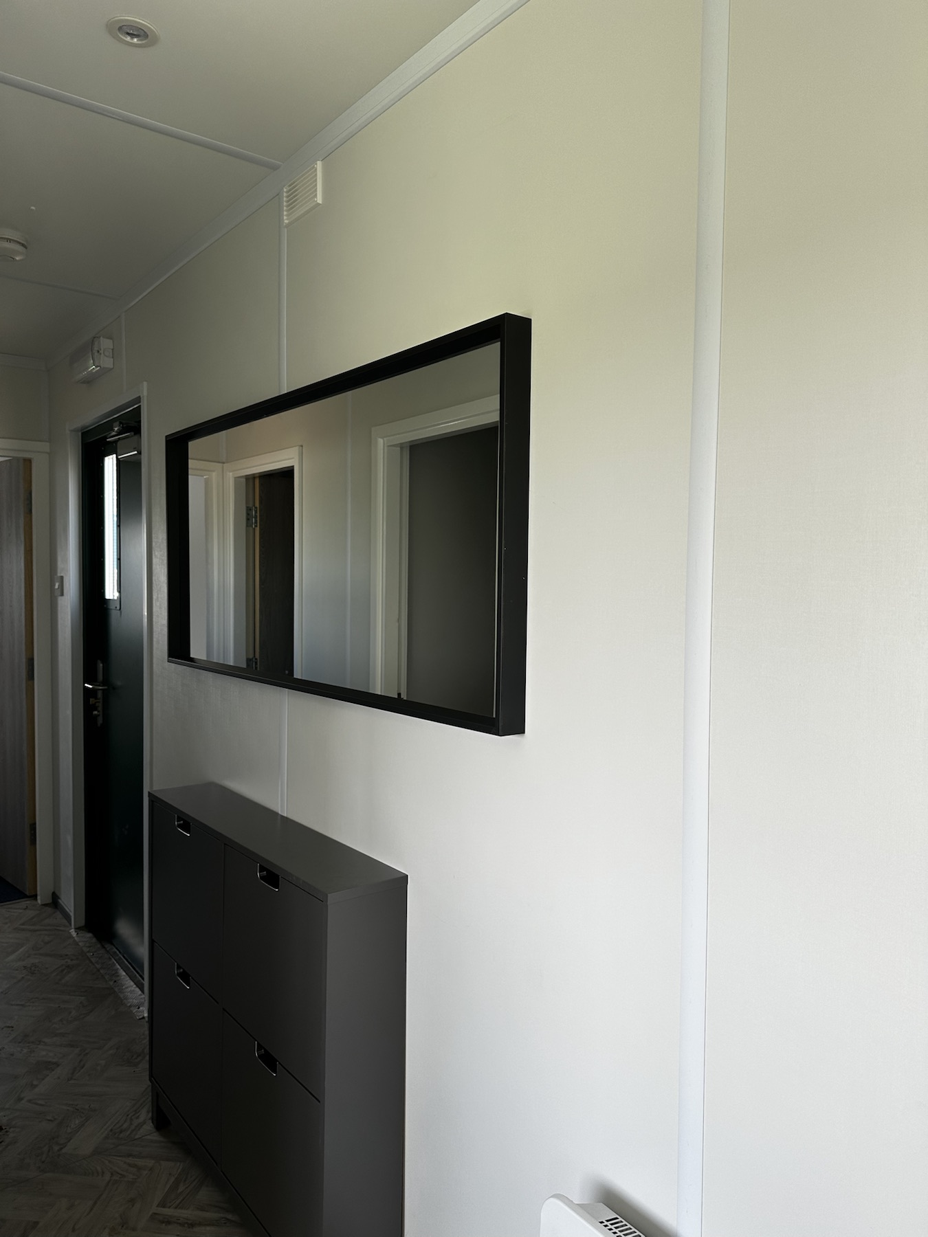 Finished hallway with storage and mirror in the Ely site accommodation