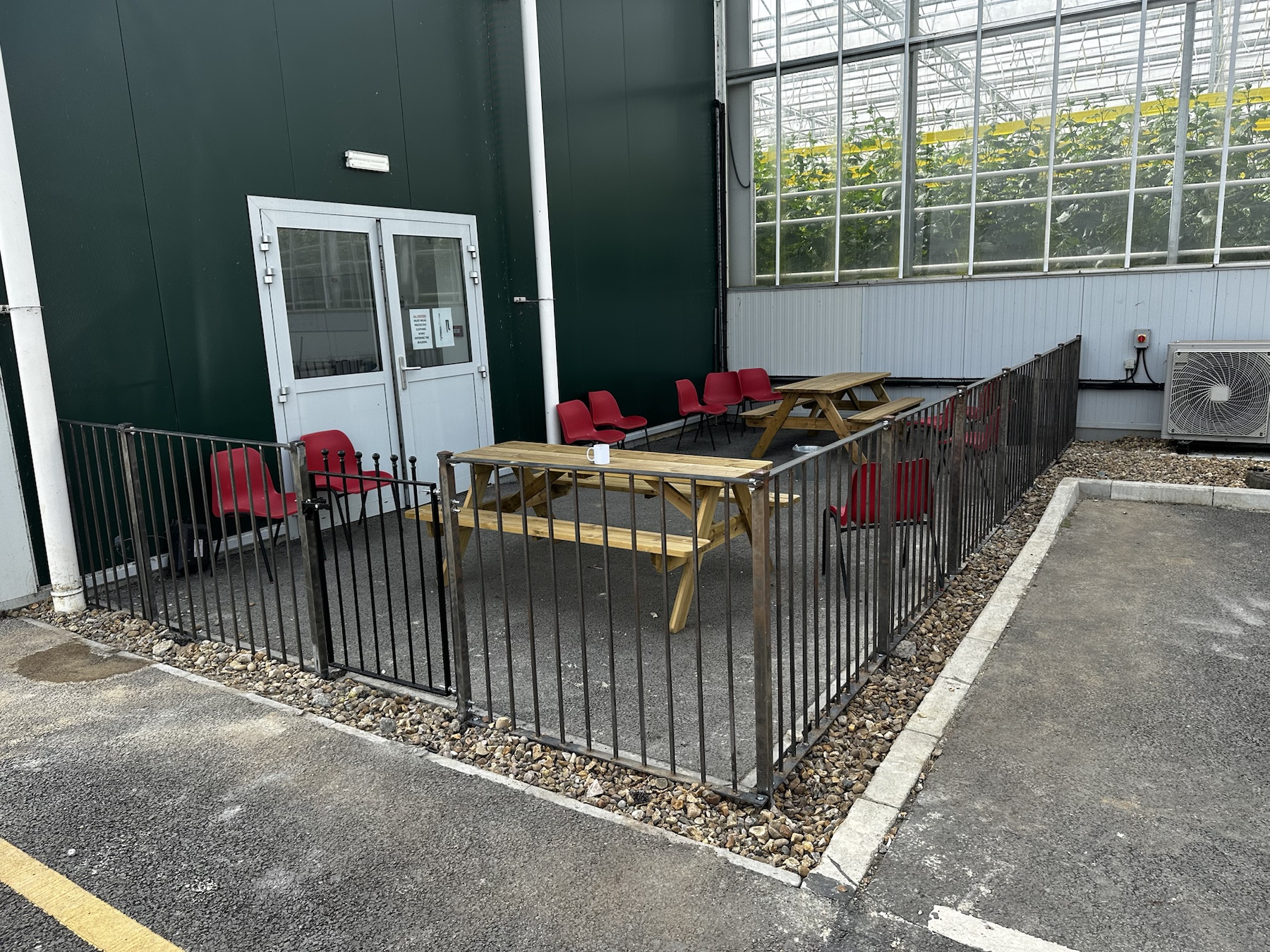 Completed 4 ft iron fencing and gate around a smoking area at The Greenhouse Growers in Ely