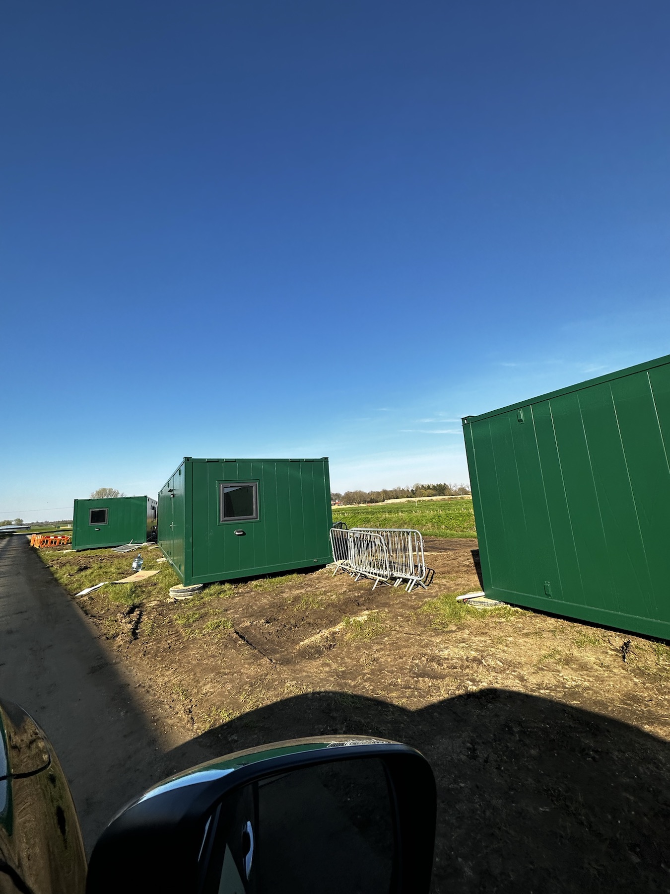 Green modular accommodation units at The Greenhouse Growers site