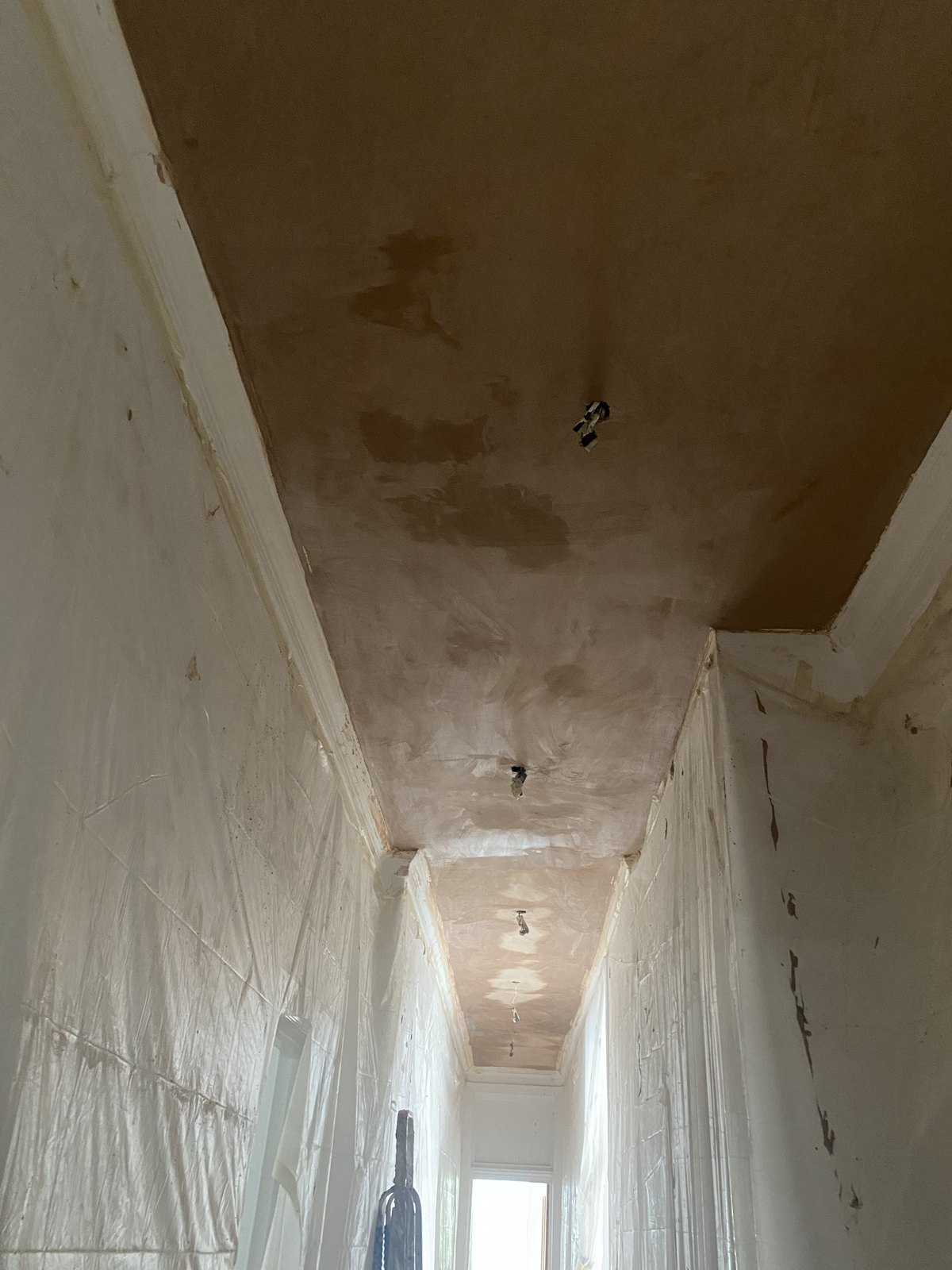 Newly plastered hallway ceiling in the Maida Vale flat