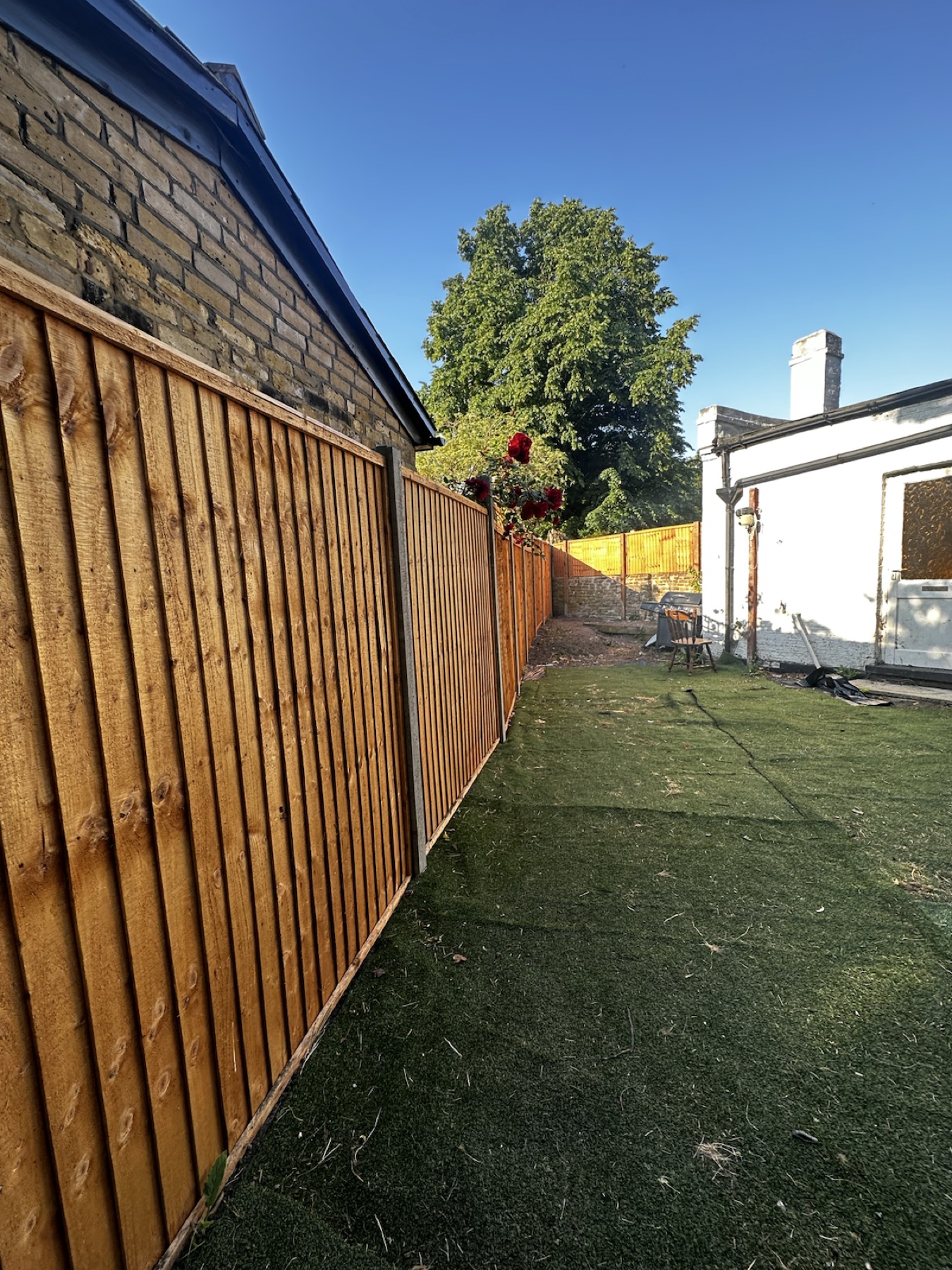 Finished side boundary fence with concrete posts in Streatham
