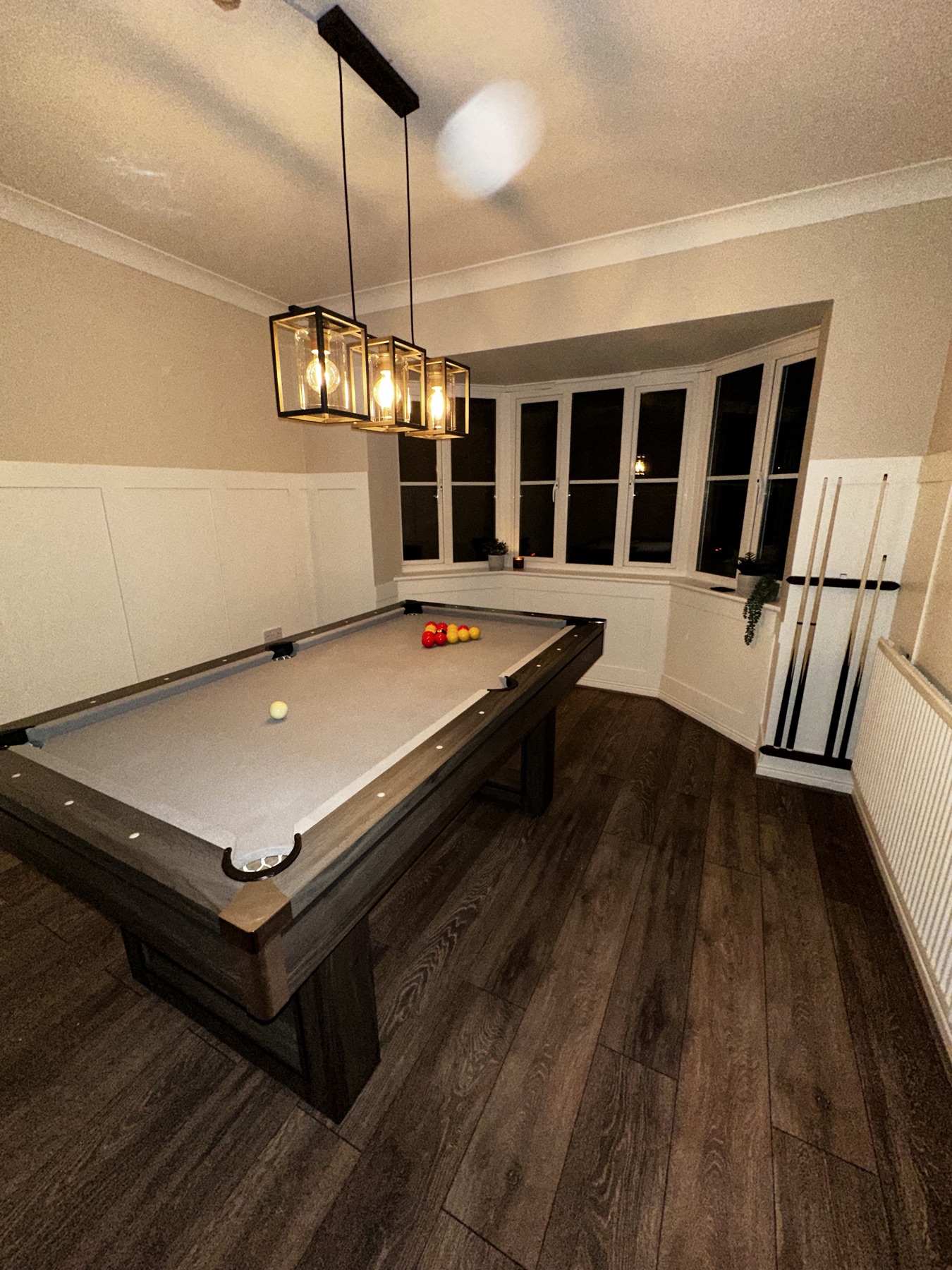 Games room after pool table assembly and feature light fitting