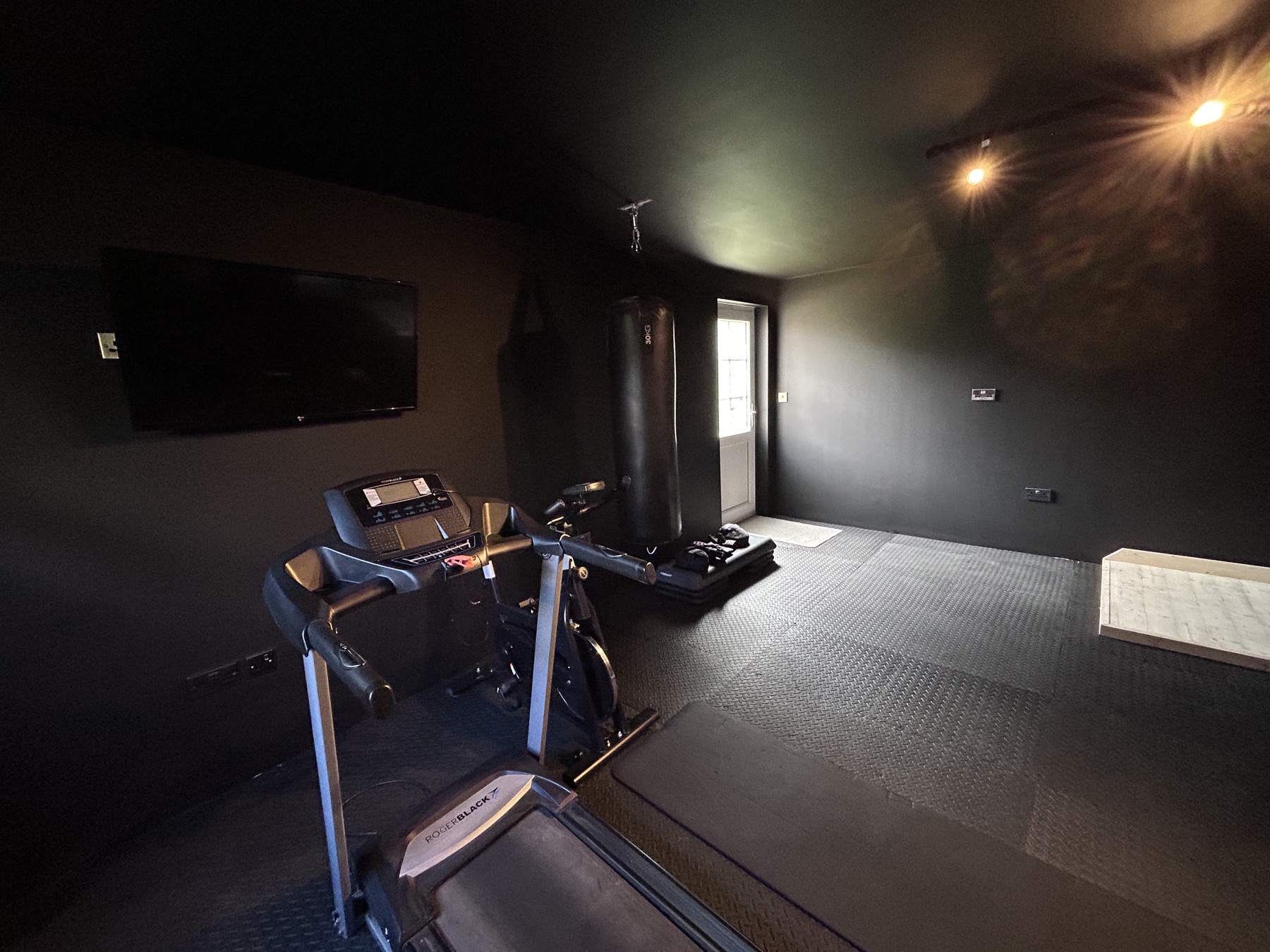 Finished home gym with rubber flooring and equipment