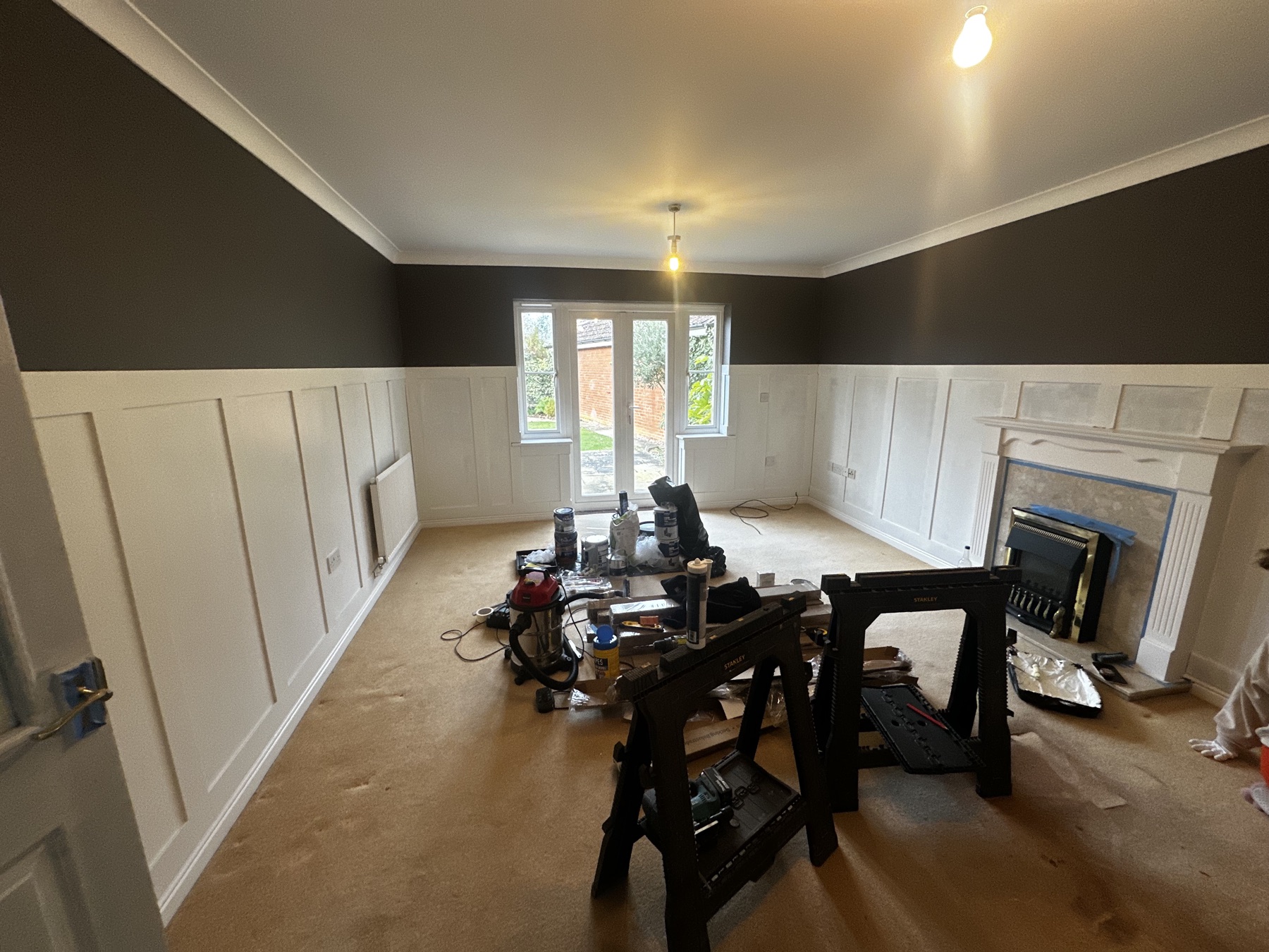 New decorative wall panelling during installation in the lounge