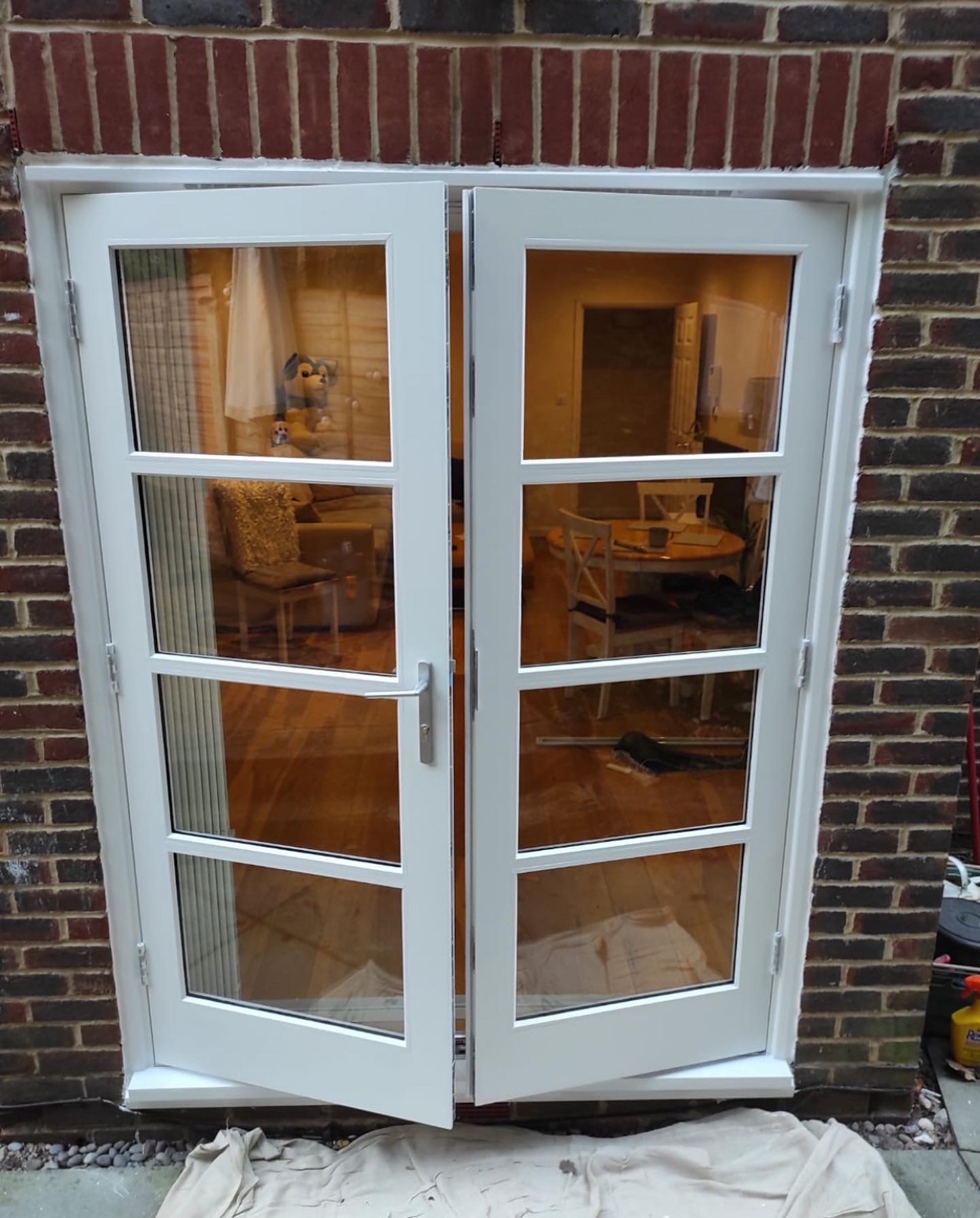 Finished white glazed garden doors set into brickwork